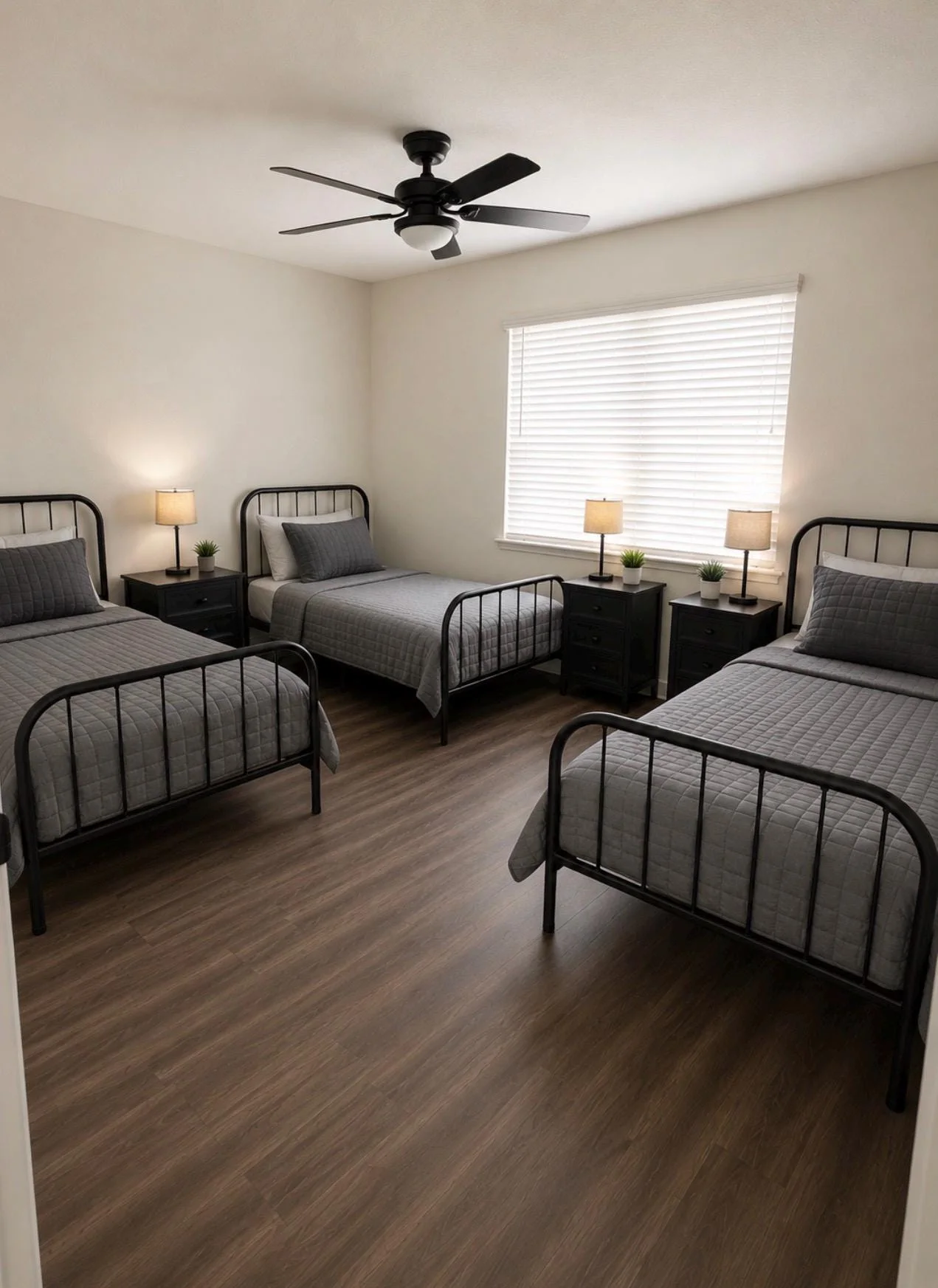 Clean shared bedroom with three individual beds